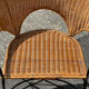 Wicker and black wrought iron armchair