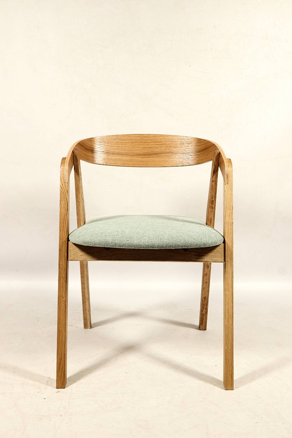 Vintage dining chair in light oak with natural linen pastel green fabric.