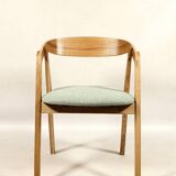 Vintage dining chair in light oak with natural linen pastel green fabric.