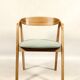 Vintage dining chair in light oak with natural linen pastel green fabric.