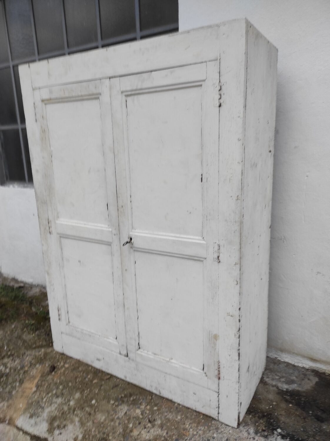 Old rustic Parisian wardrobe patinated white in oak and fir