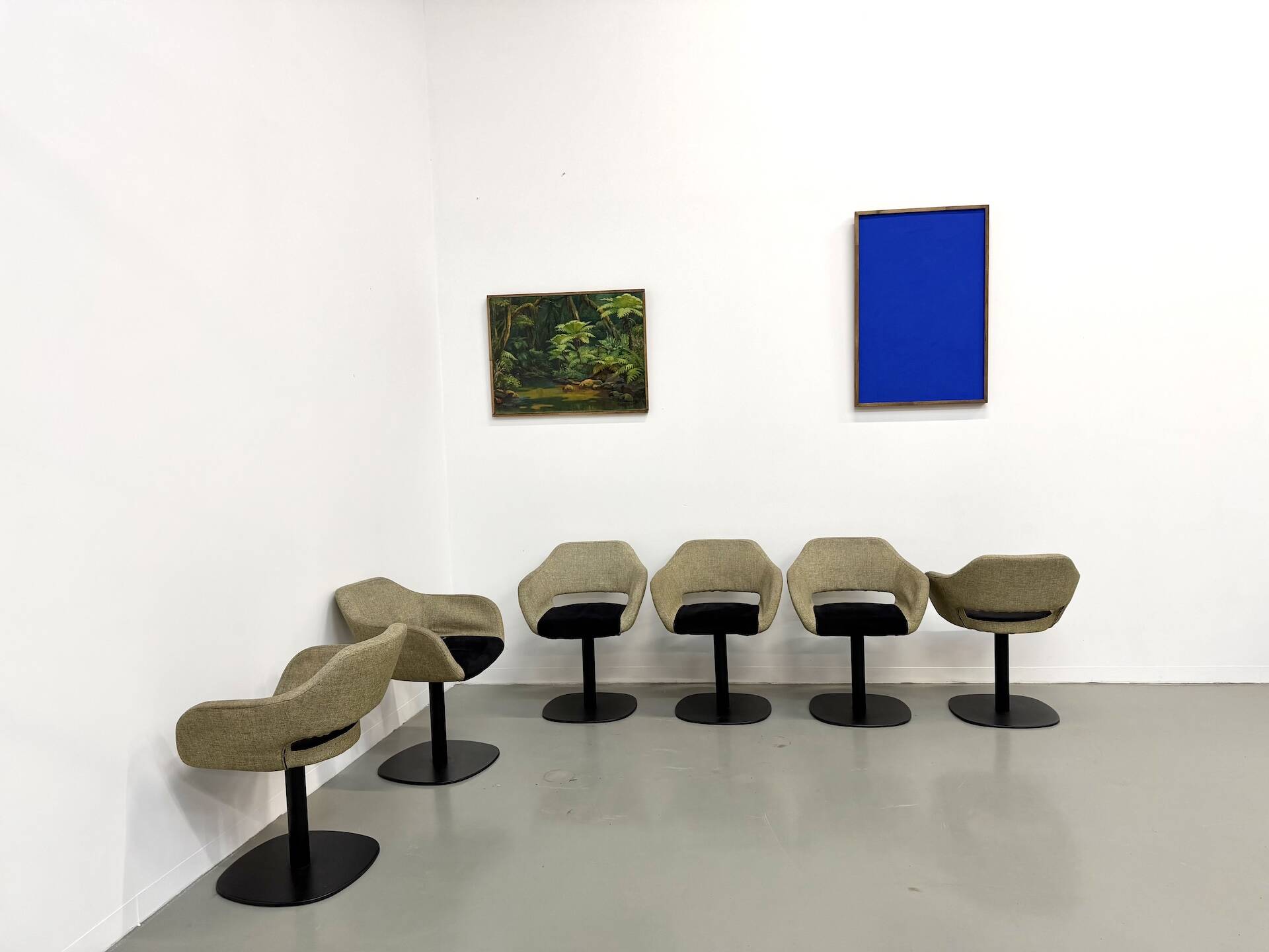 Series of six swivel chairs with an organic shell, patterned fabric and base.