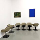 Series of six swivel chairs with an organic shell, patterned fabric and base.