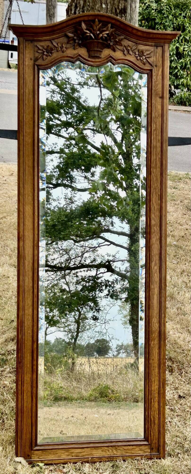 Large and old bevelled framed floor mirror.