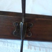 old wall coat holder made up of 3 wooden and metal pads.