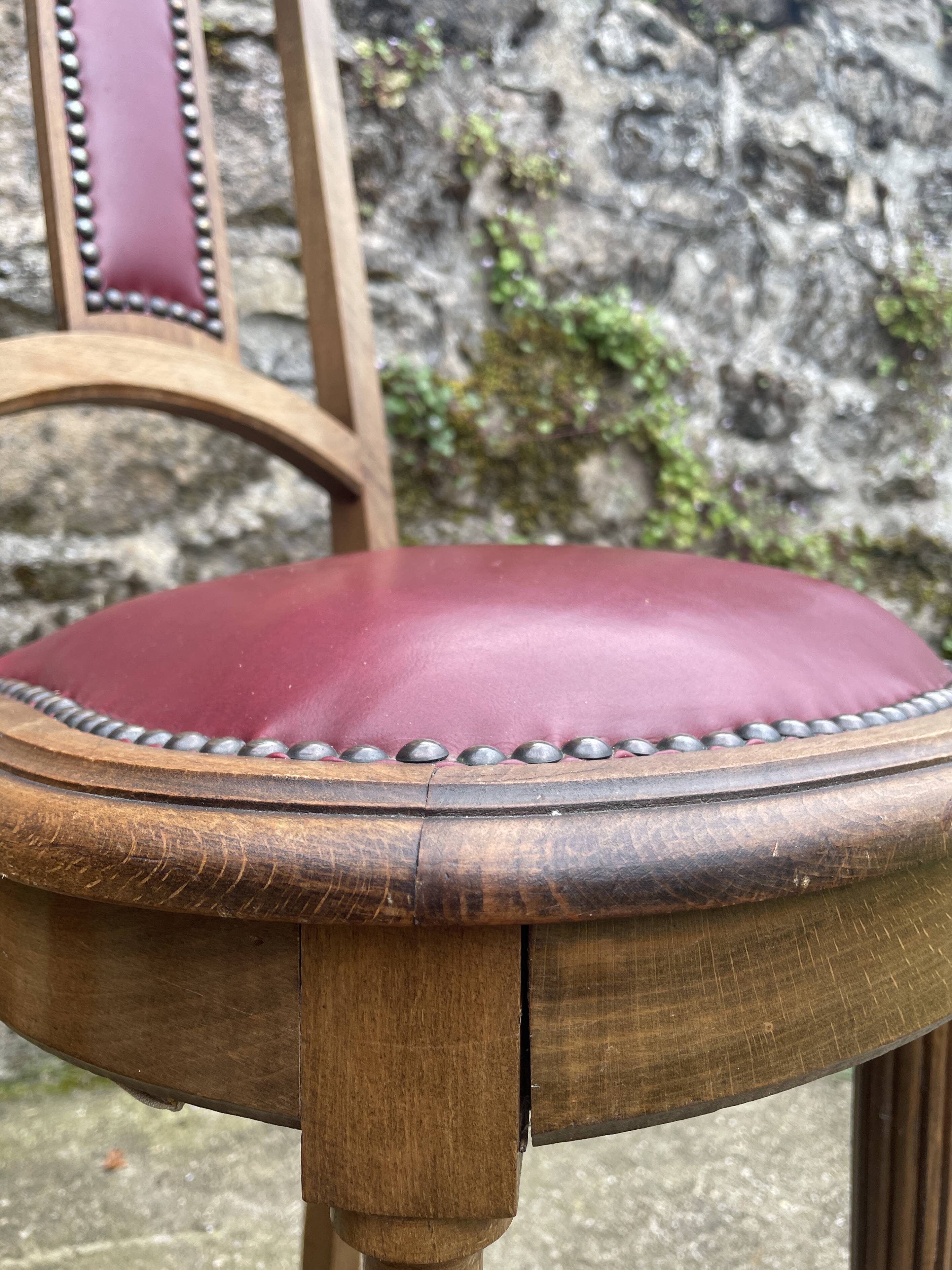 Pair of studded burgundy leather Art Deco chairs