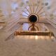 Pair of wall lights with hanging glass pendants in gold color