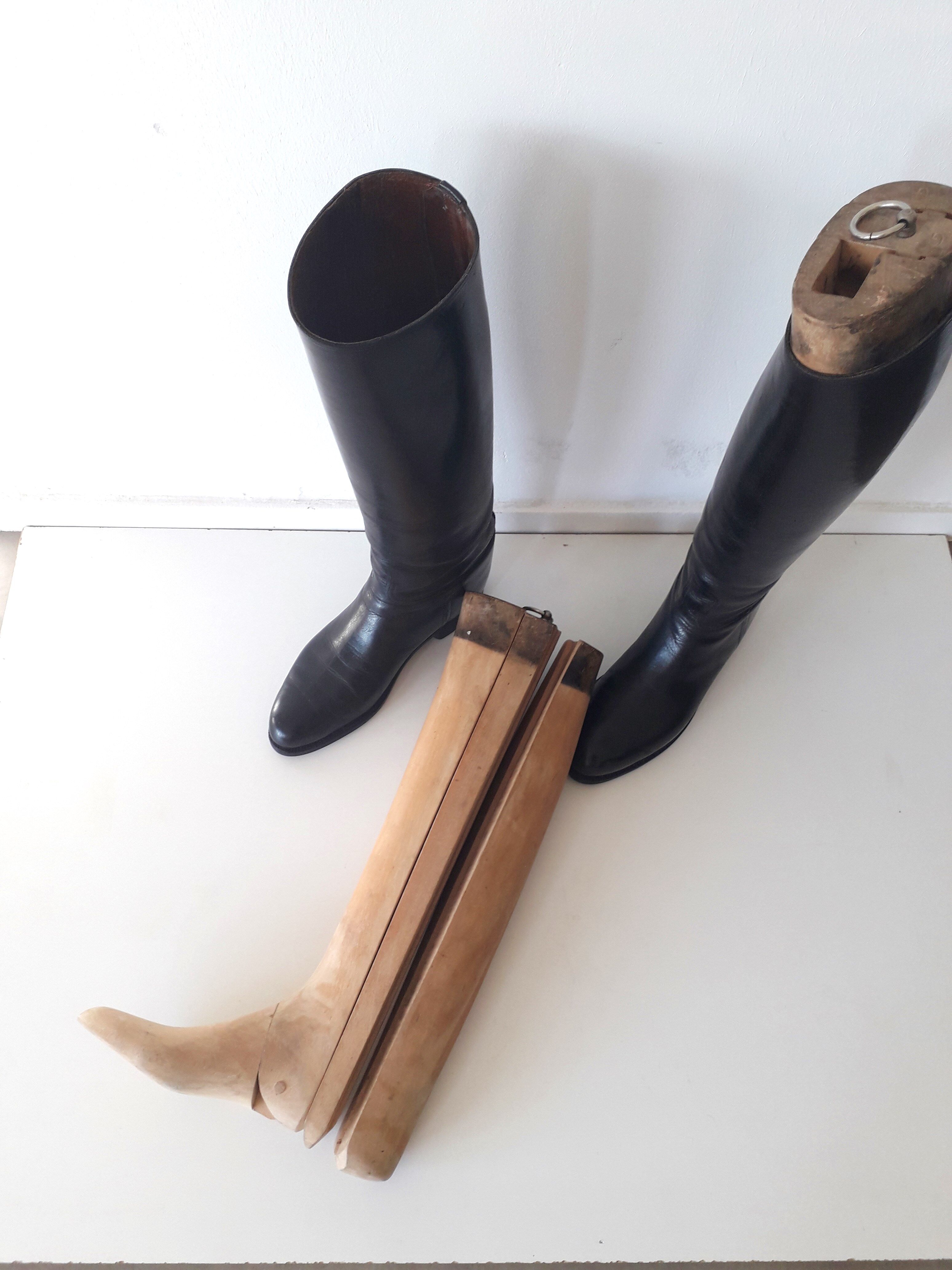 Old wooden shoe trees and their vintage leather rider boots. 1950