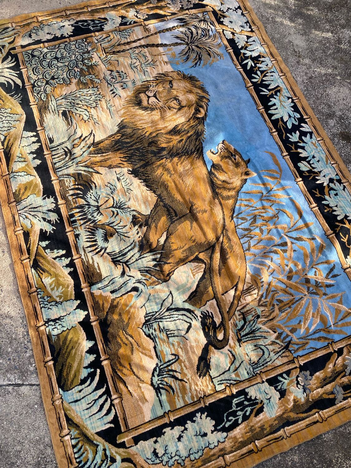 Antique velvet wall tapestry depicting a lion and lioness scene