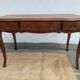 Louis XV style desk in wood, with a brown leather top.