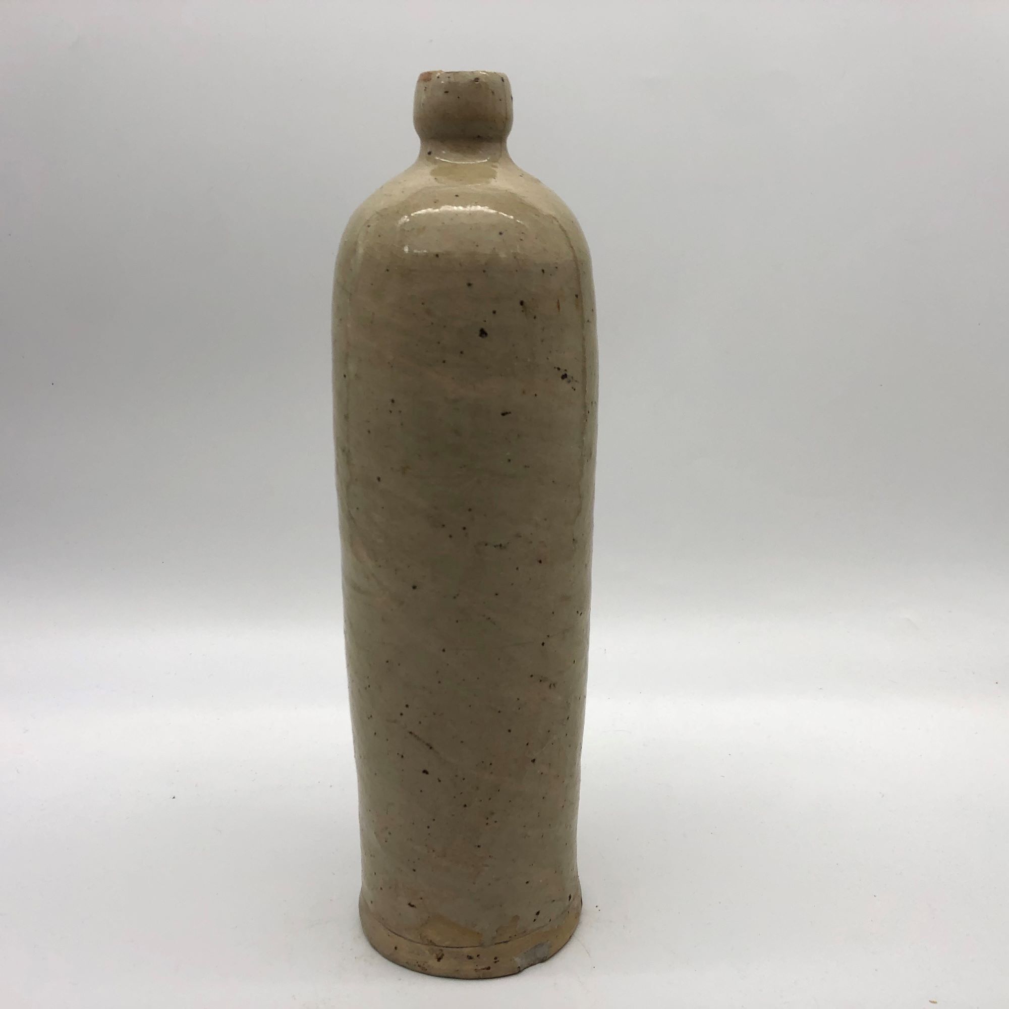 Old hot water bottle in glazed stoneware, beige color