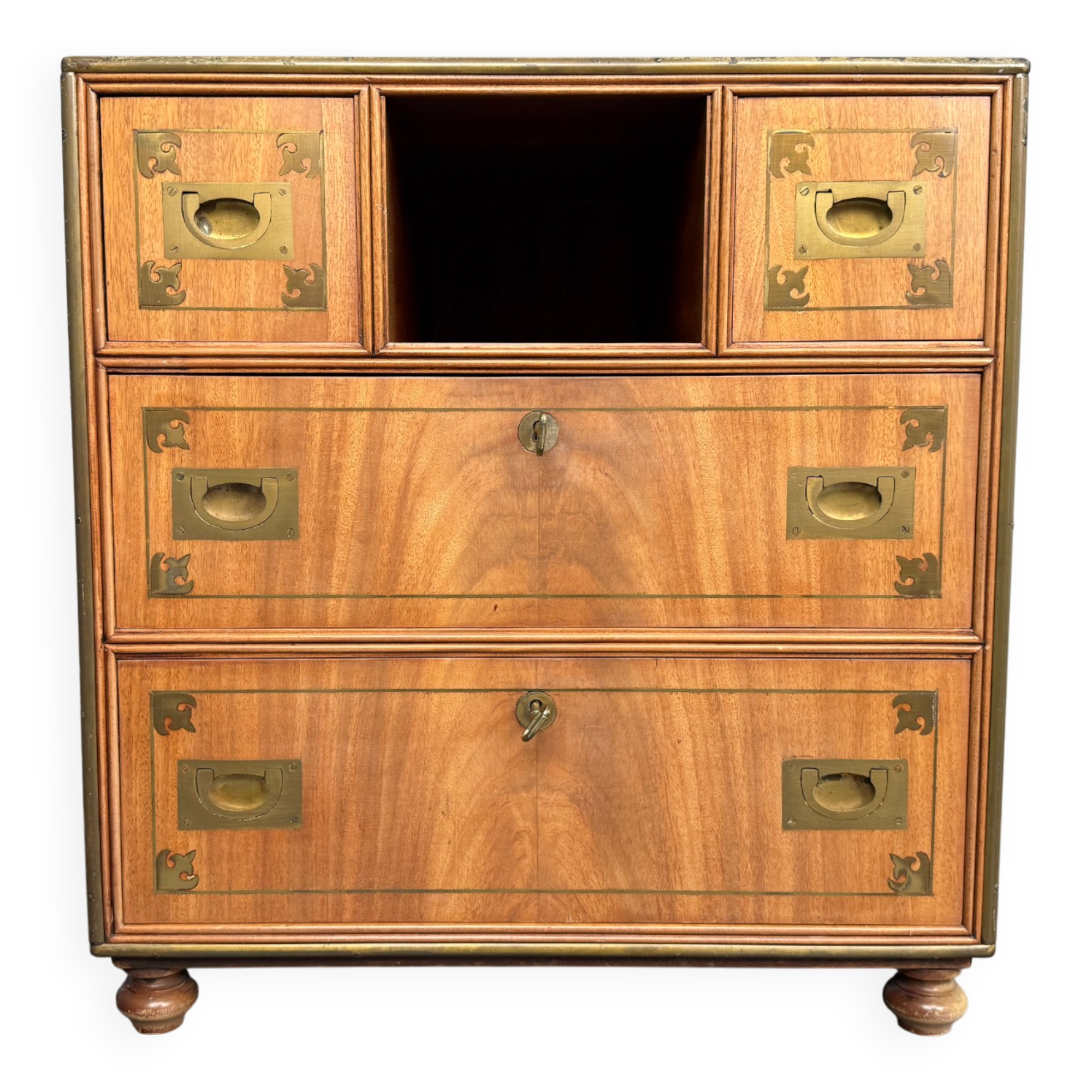 Antique campaign chest / ship’s chest, England, 1940s. Mahogany with a distinctive grain, brass inlays and hardware.