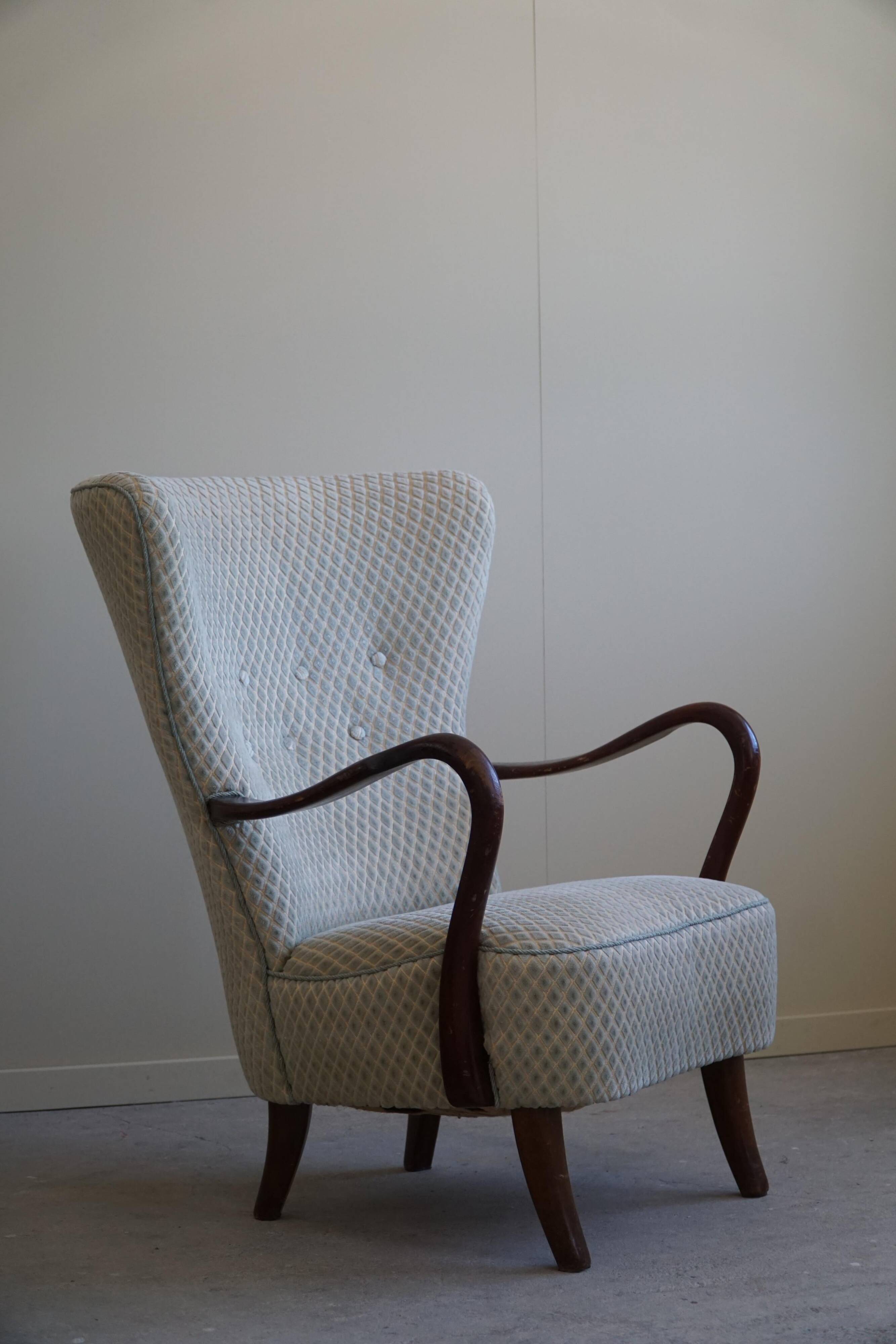 Slagelse Møbelfabrik, modern Danish lounge armchairs with beech footrests, 1960s.