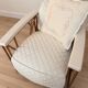 ENNIO armchair in quilted white leather with a copper stainless steel frame.