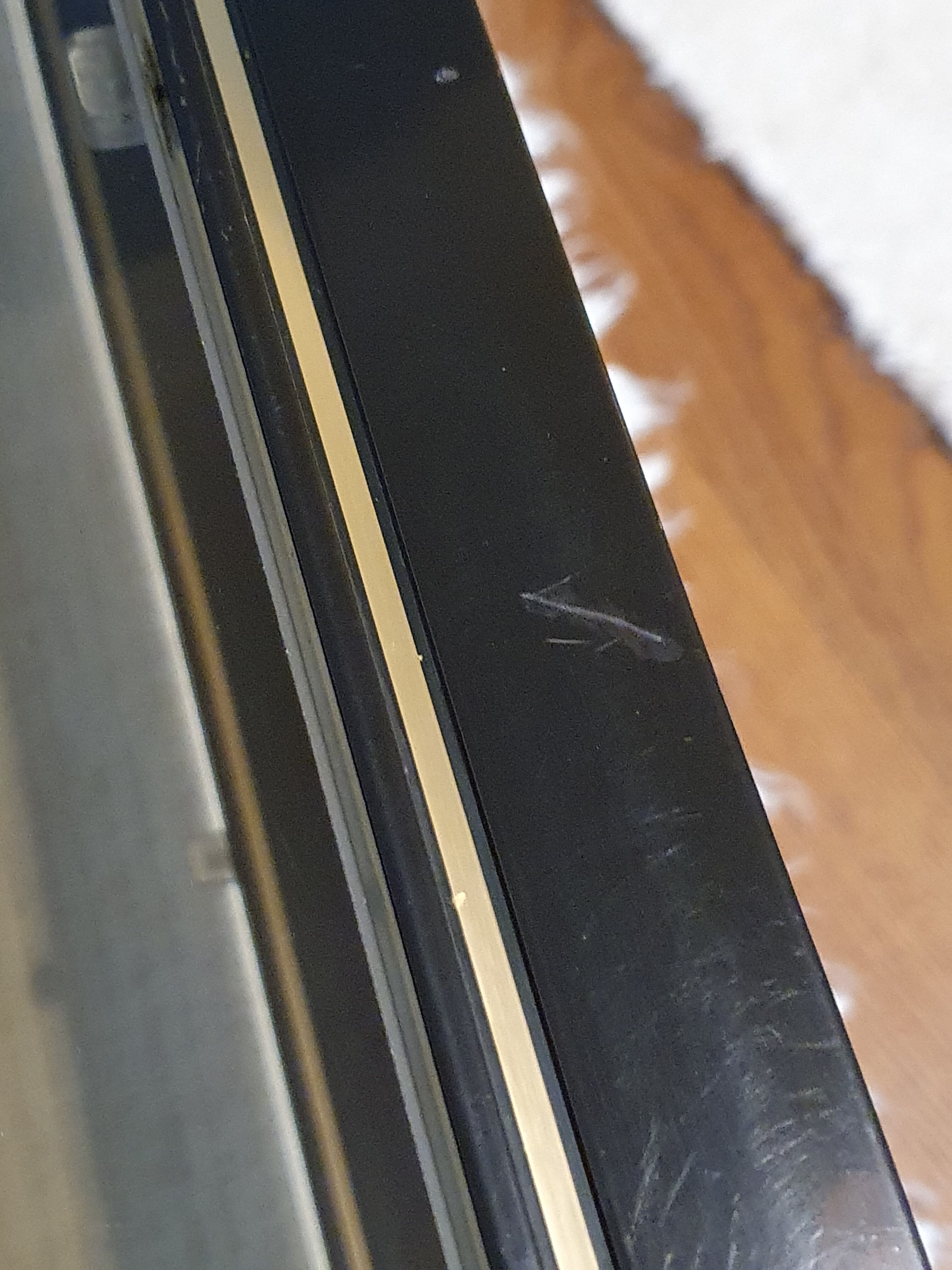 Black and gold coffee table with a double smoked glass top