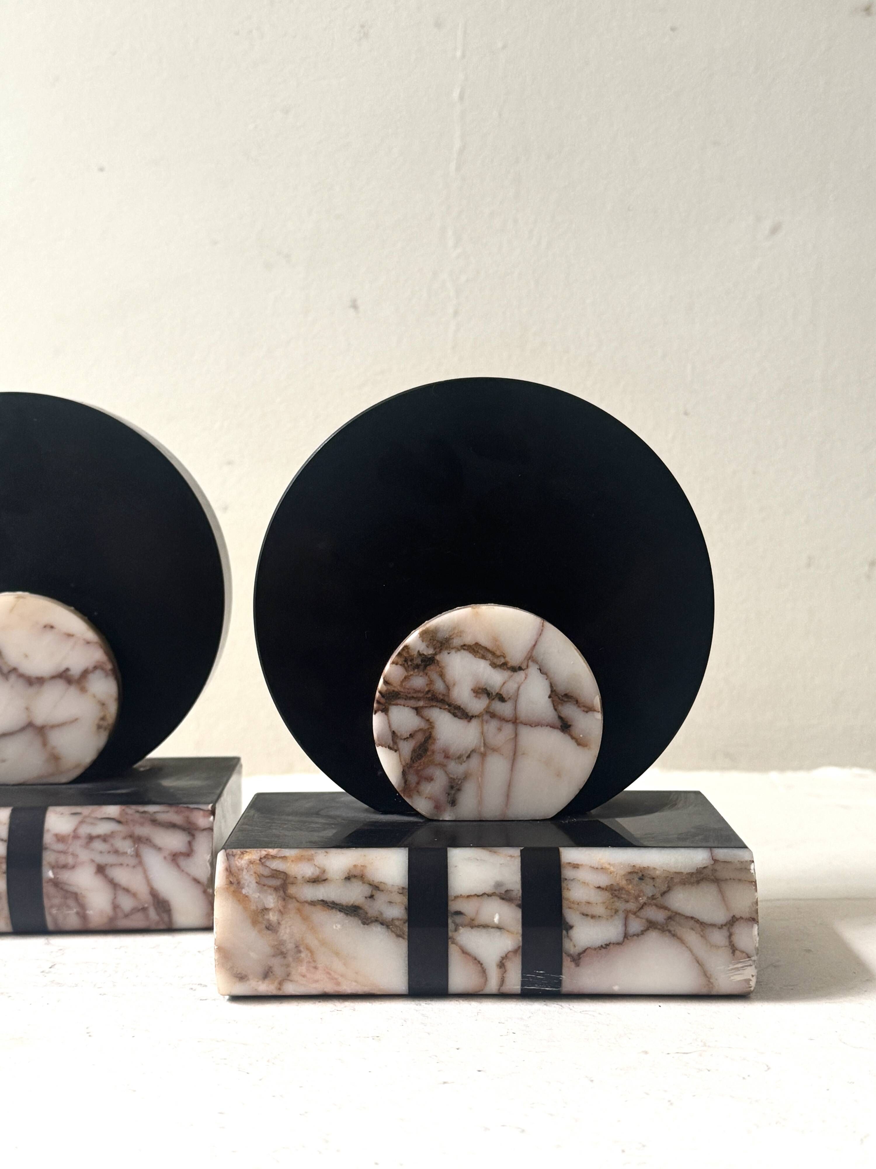 Art Deco bookends with a circular design in black and pink marble.