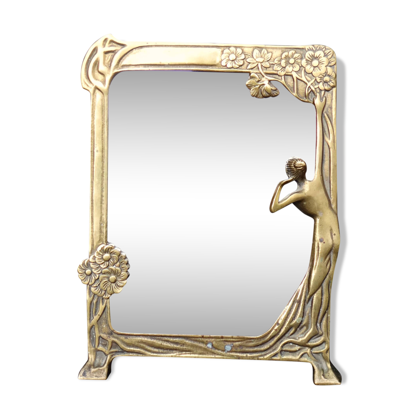 Art Nouveau mirror in gilded brass with a woman figure emerging from a vintage frame