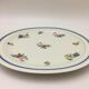 Round serving dish "lourioux foëcy" with flower motifs.
