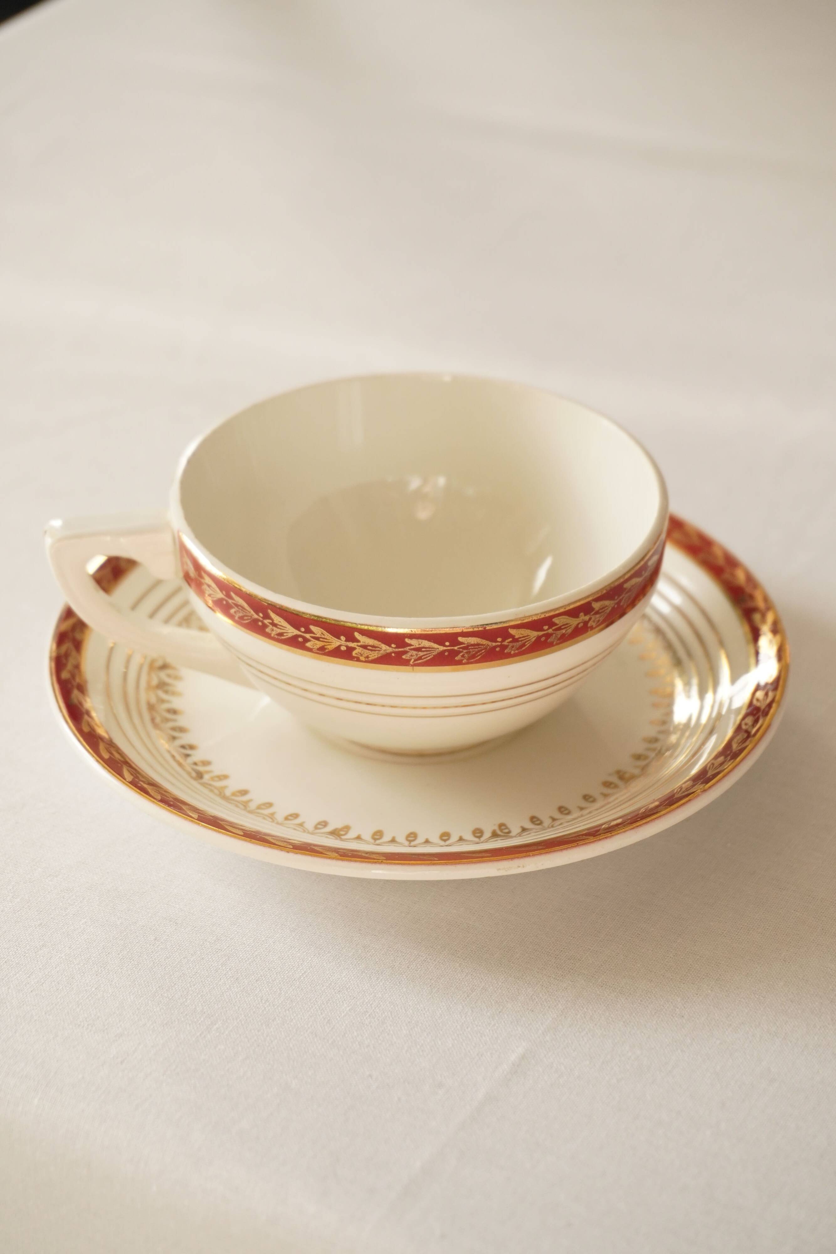 Set of 4 white, red and gold porcelain teacups, Ceranord
