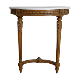 Half-moon console in Louis XVI style made of carved wood.