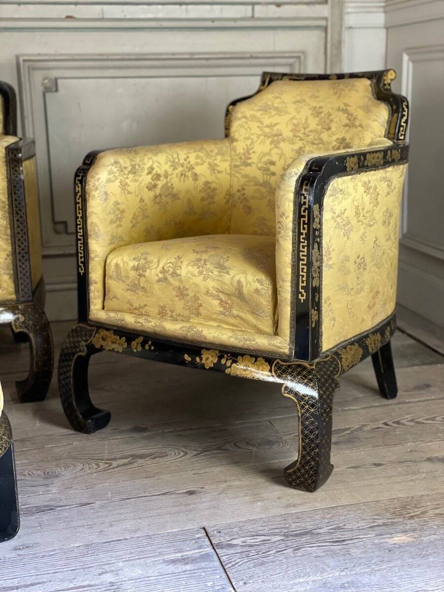 A set of two armchairs, a sofa and two poufs in lacquered wood with gilded chinoiserie decoration.