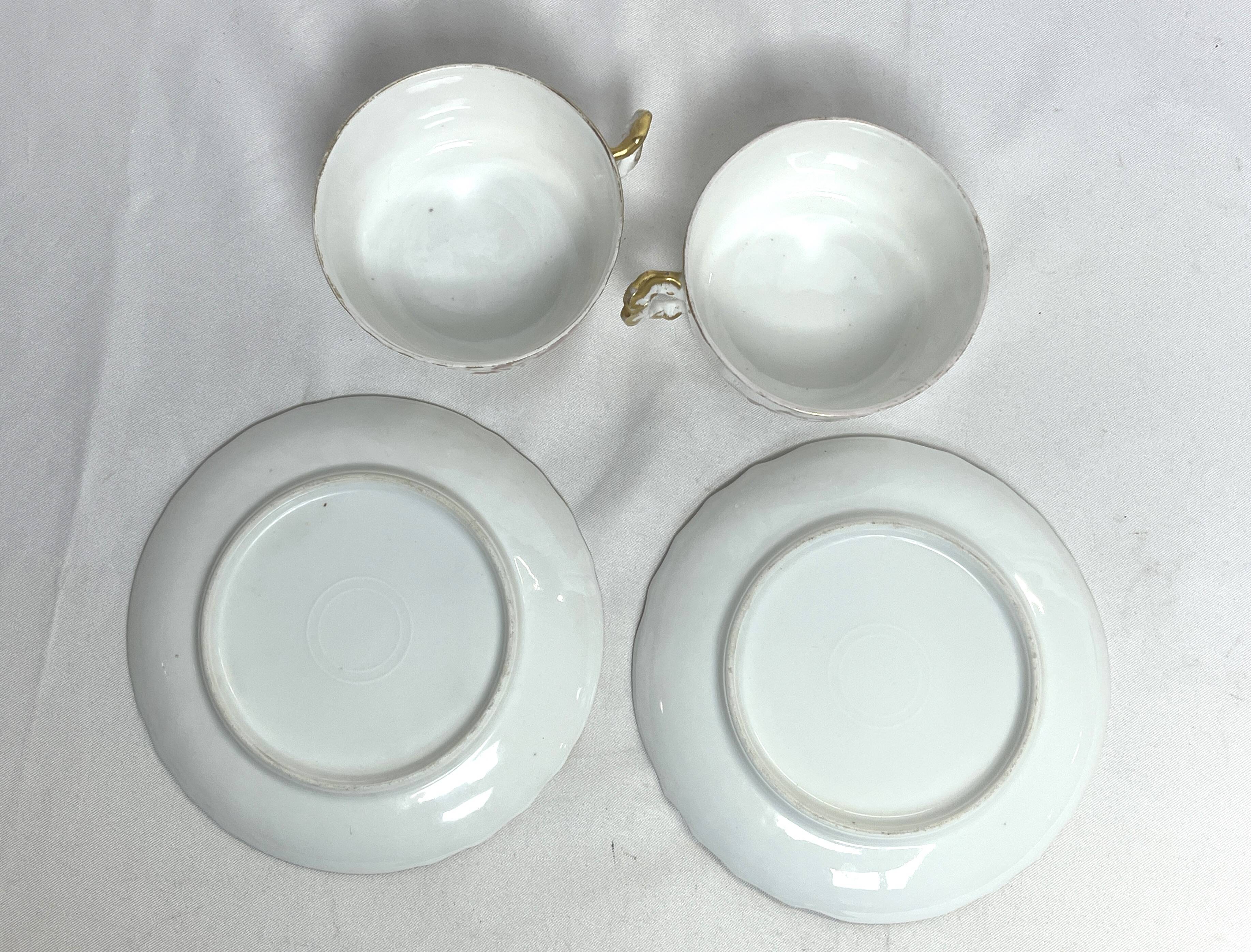 Two English porcelain teacups with floral decoration, 19th century