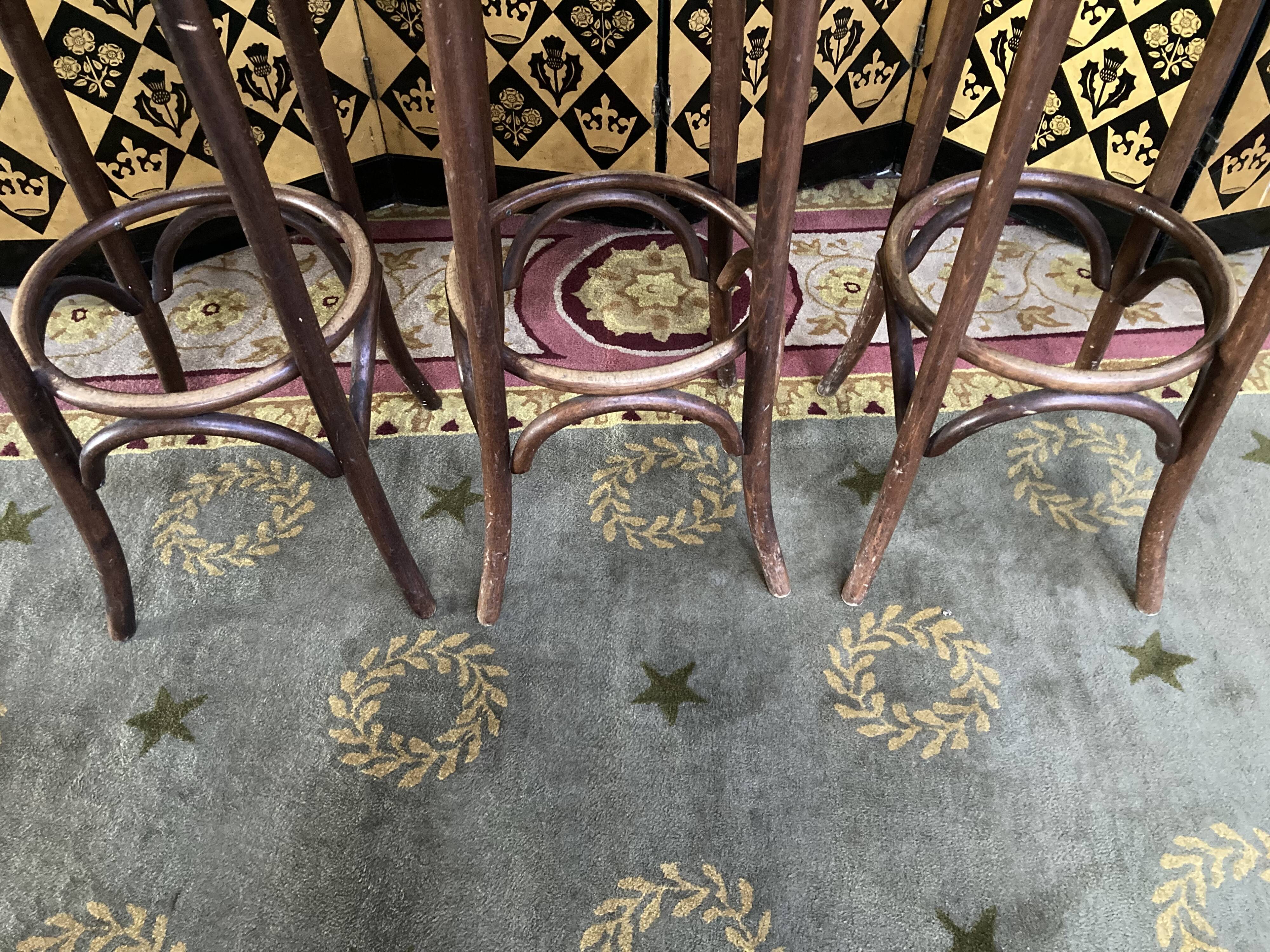 3 curved wooden bar stools