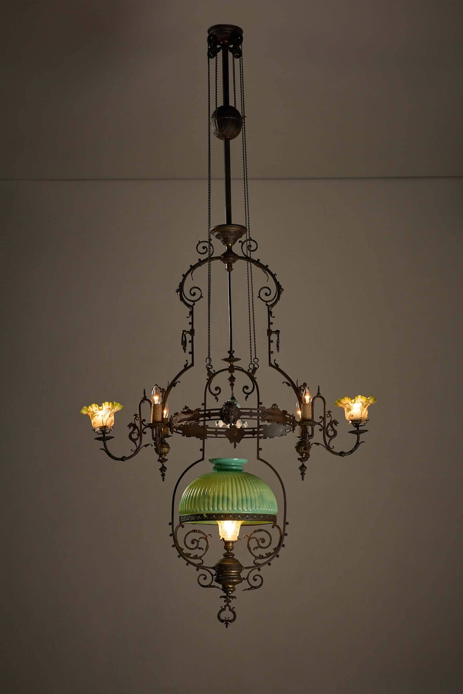 Antique adjustable height chandelier with original glasswork and brass detailing