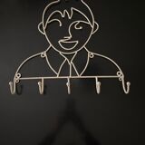 Pair of iron coat holders girl and boy