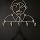 Pair of iron coat holders girl and boy