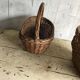 Set of 2 brown wicker baskets from the 1960s — decorative weaving and double handles.