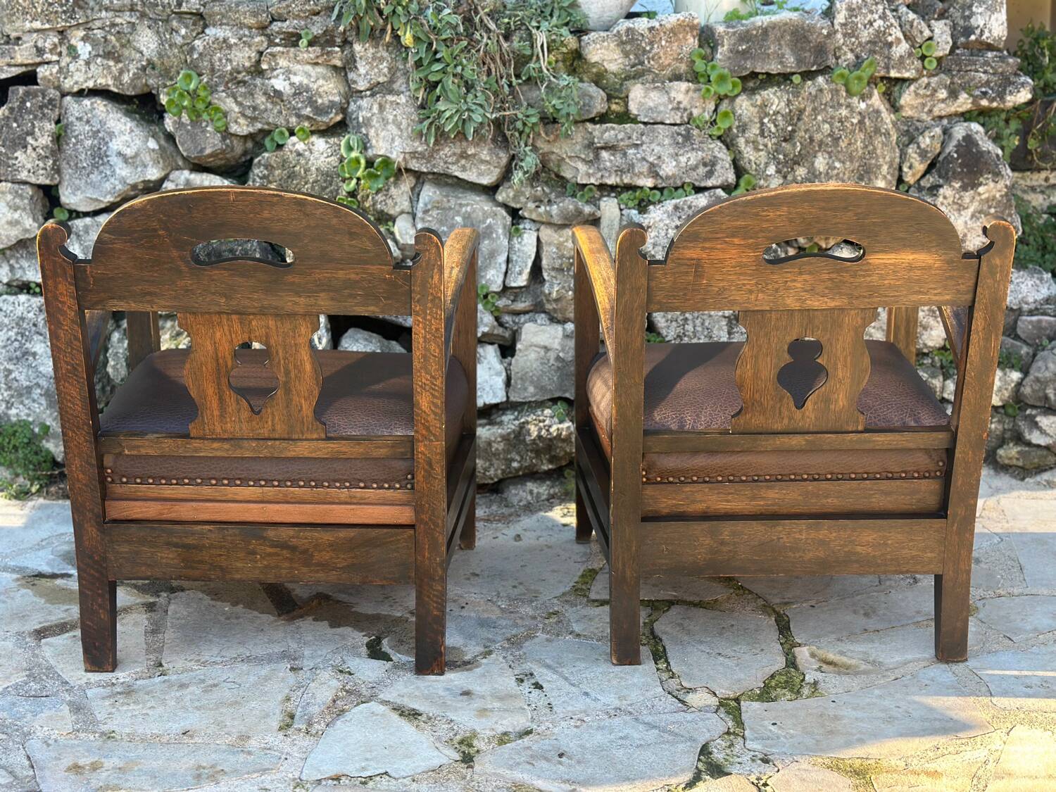 Pair of armchairs in stained wood and leather, 20th century