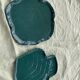 Two dishes empty pocket slurry, biscuits in the shape of vintage green leaf