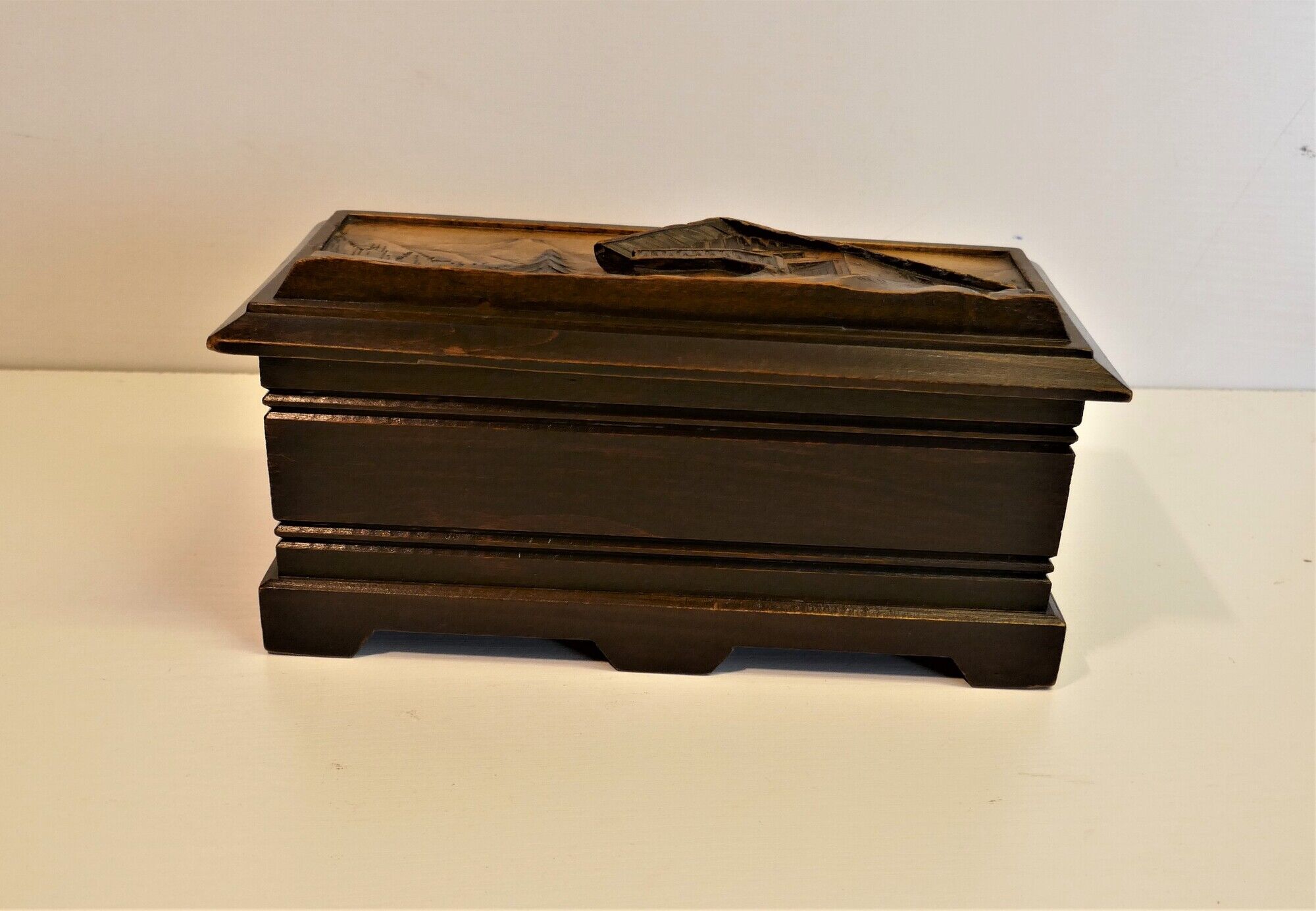 Vintage carved wooden box of a mountain landscape in relief