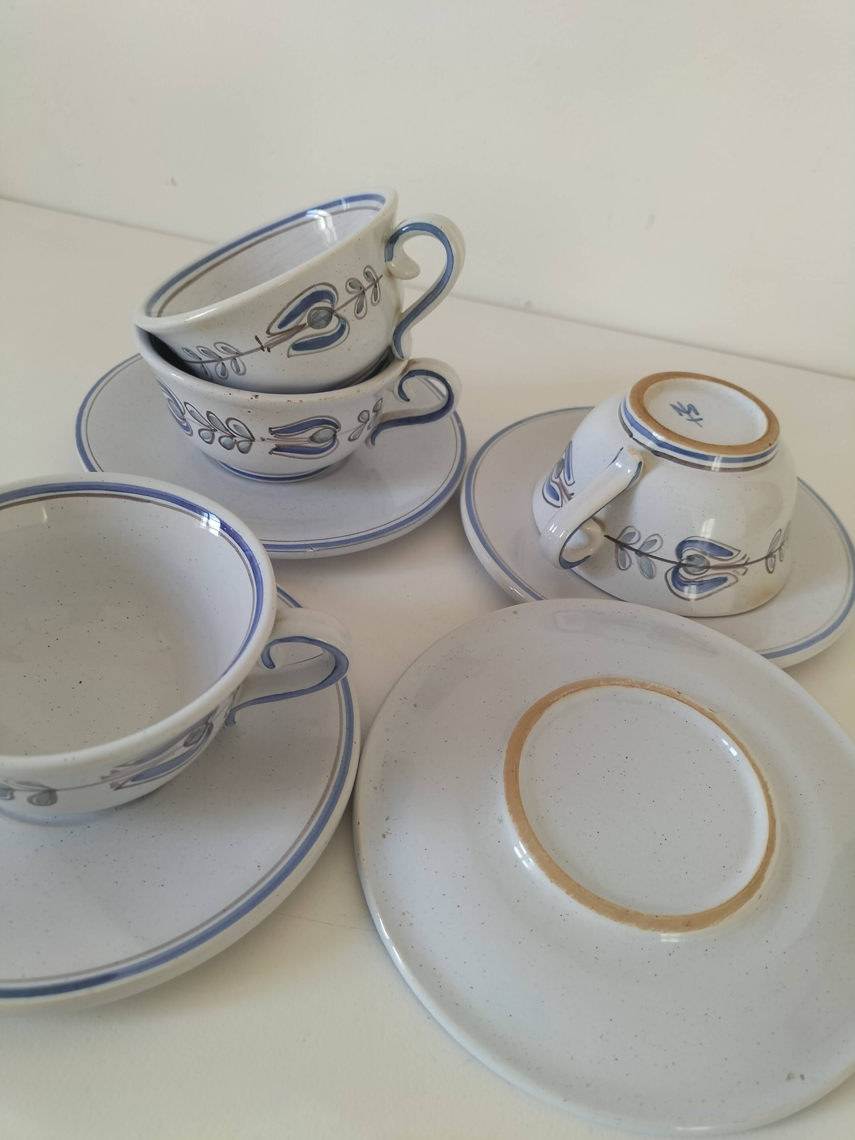 Glazed earthenware cups and saucers