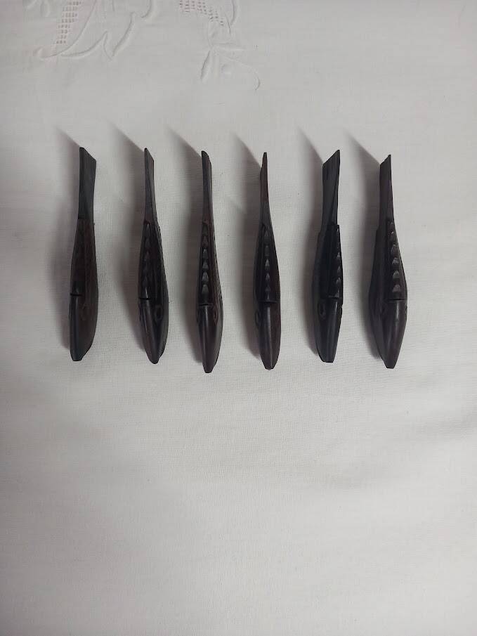 Antique wooden knife rests.