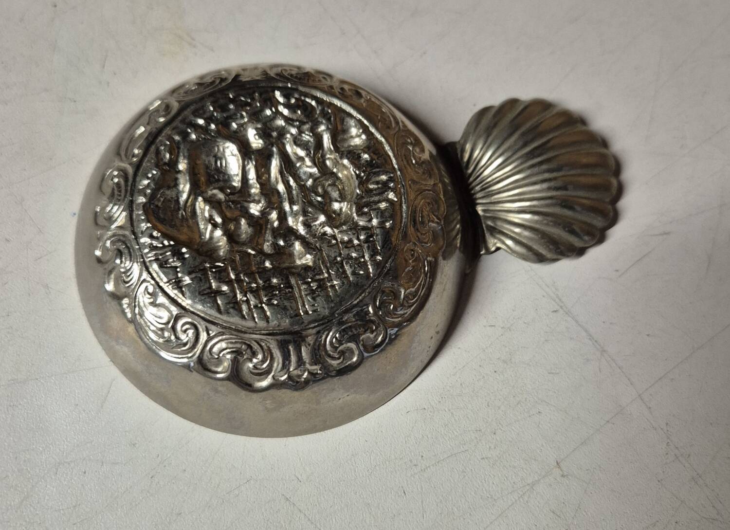 Antique silver-plated metal tastevin with tavern scene decor and shell handle