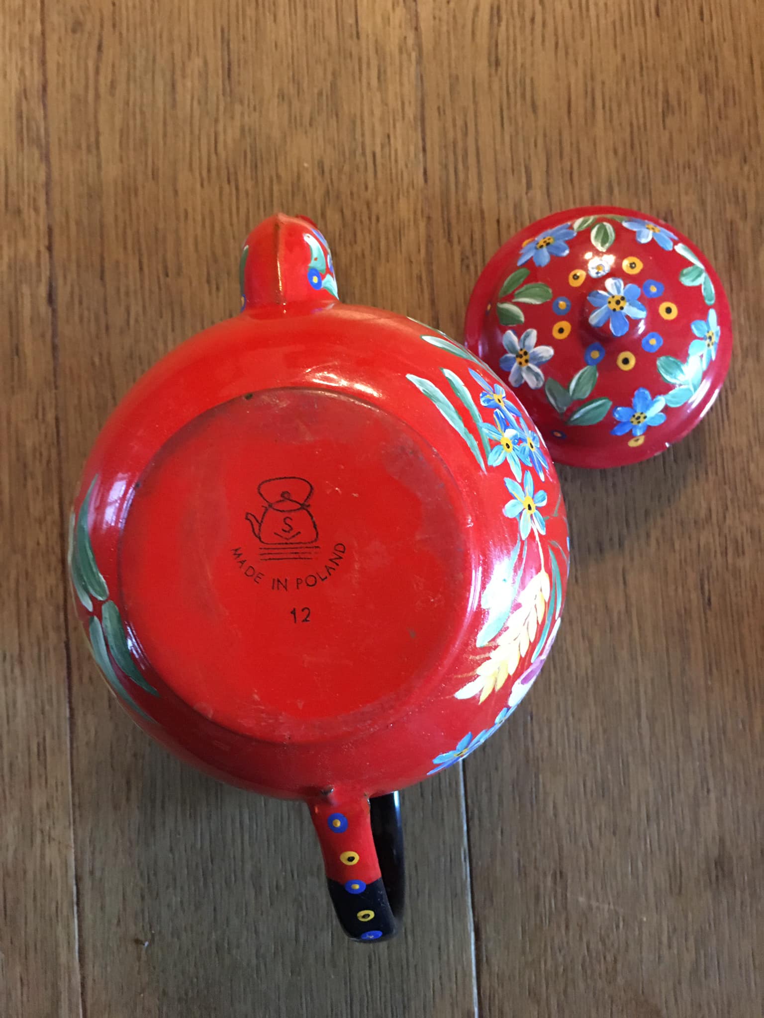 Red enamel teapot with hand-painted floral decoration