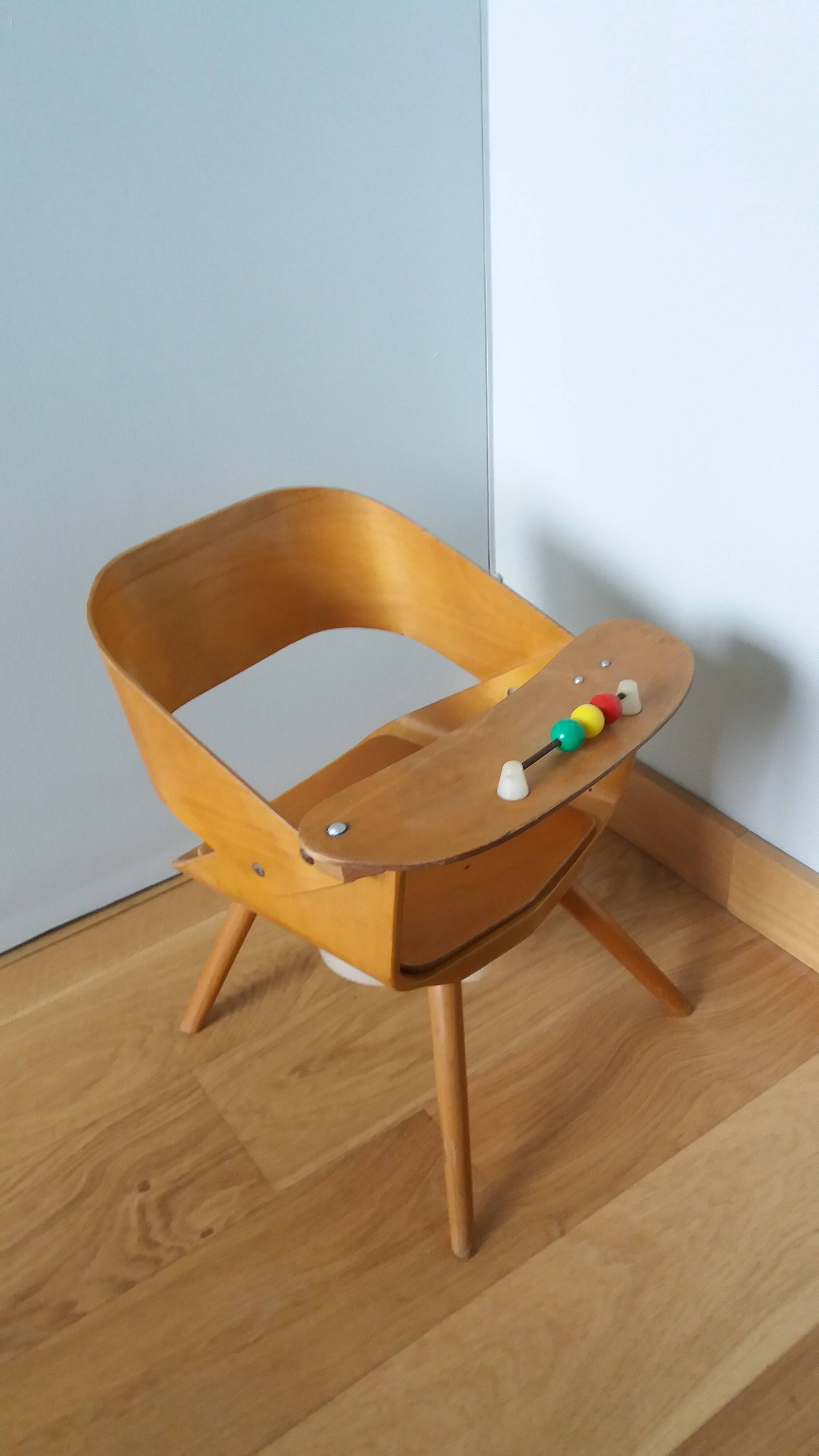 Baumann Baby Coquille children's armchair in bent wood with splayed legs.