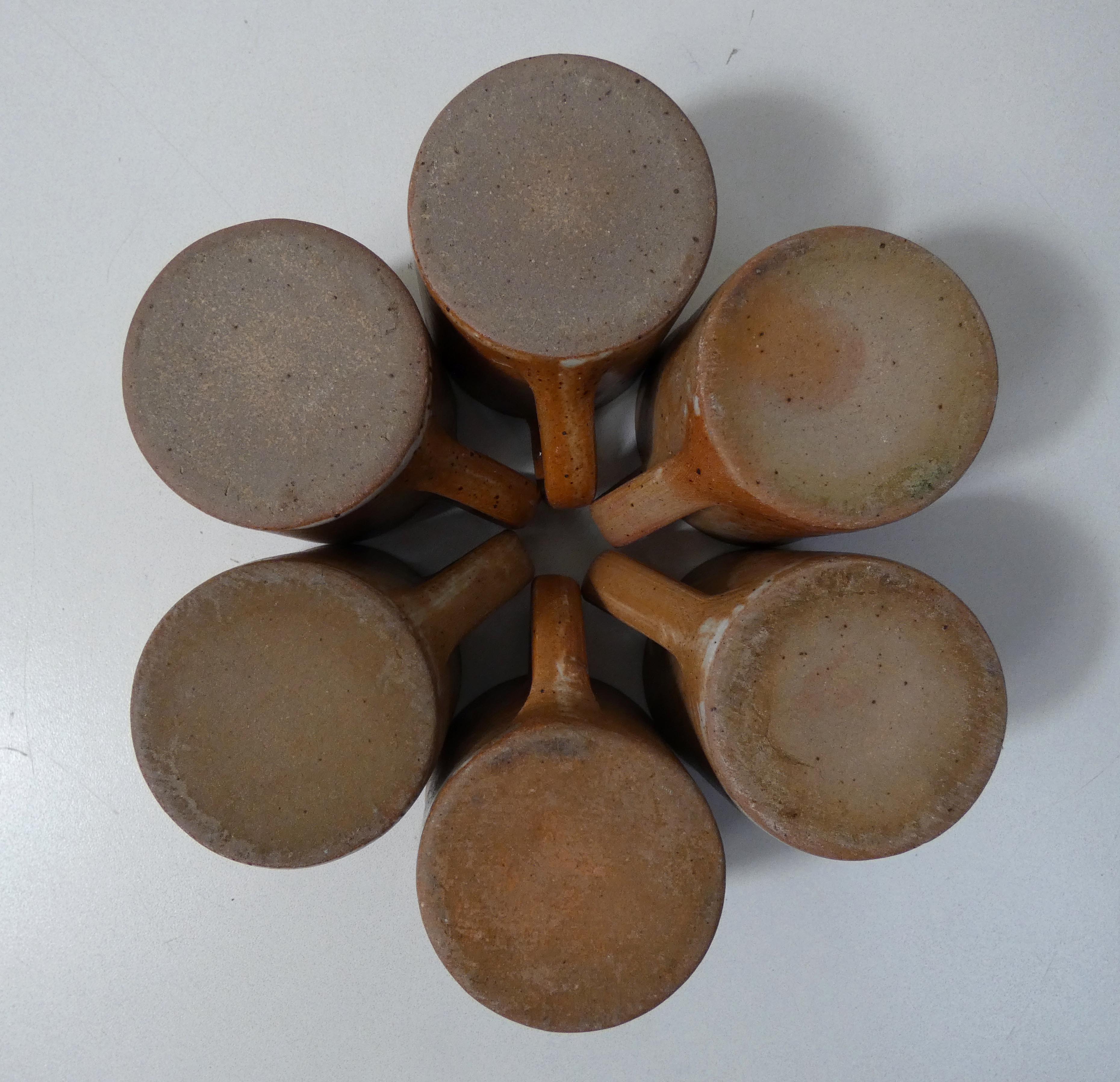 6 stoneware cups and saucers