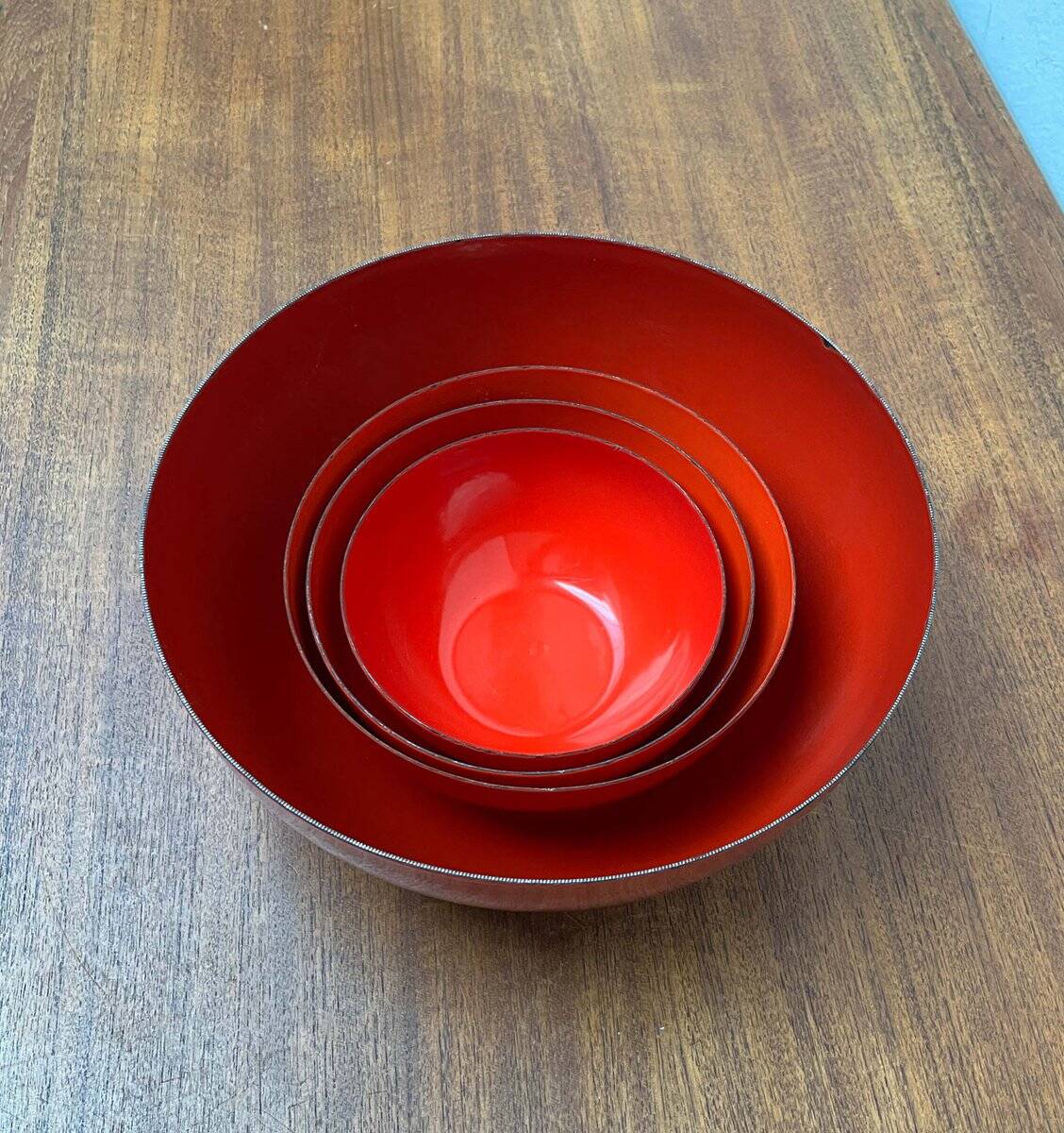 Modern mid-century red enamel bowl sets by Kaj Franck for Finel, Finland, 1960s, set of 4.