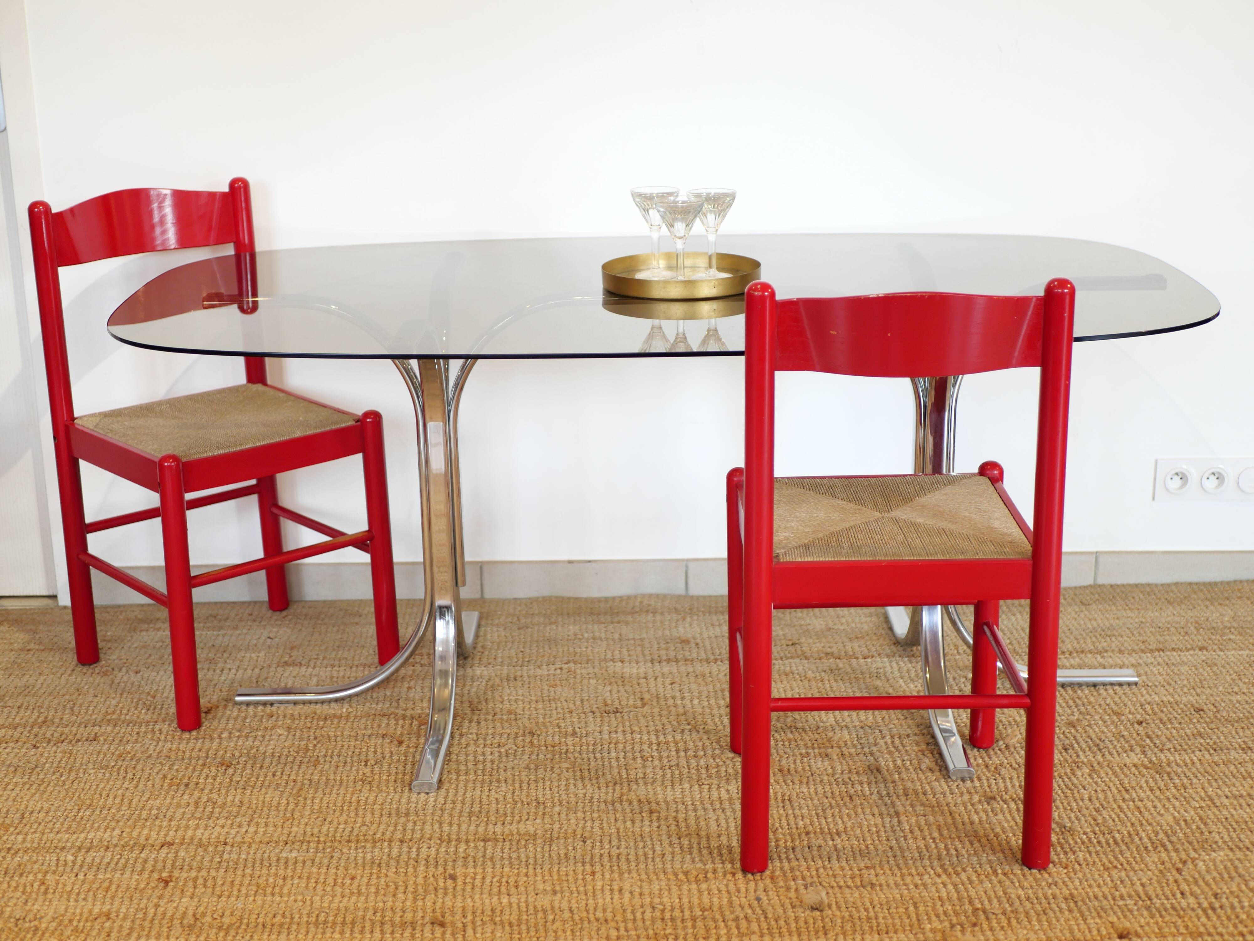 Dining table with smoked glass top and chrome base.