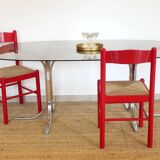 Dining table with smoked glass top and chrome base.
