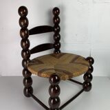 Brutalist wood turned bobbin low rush chair n the style of Charles Dudouyt