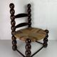 Brutalist wood turned bobbin low rush chair n the style of Charles Dudouyt