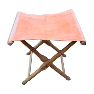 Old folding stool in wood and canvas