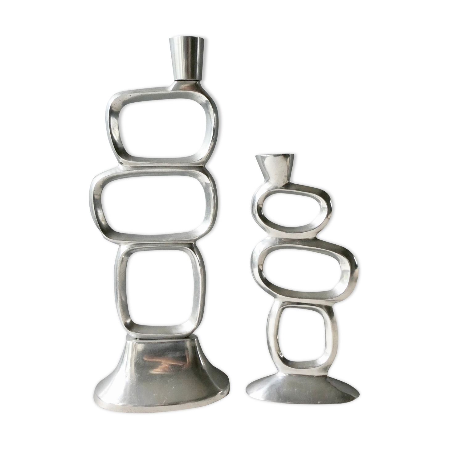 Pair of cast aluminum candle holders, design