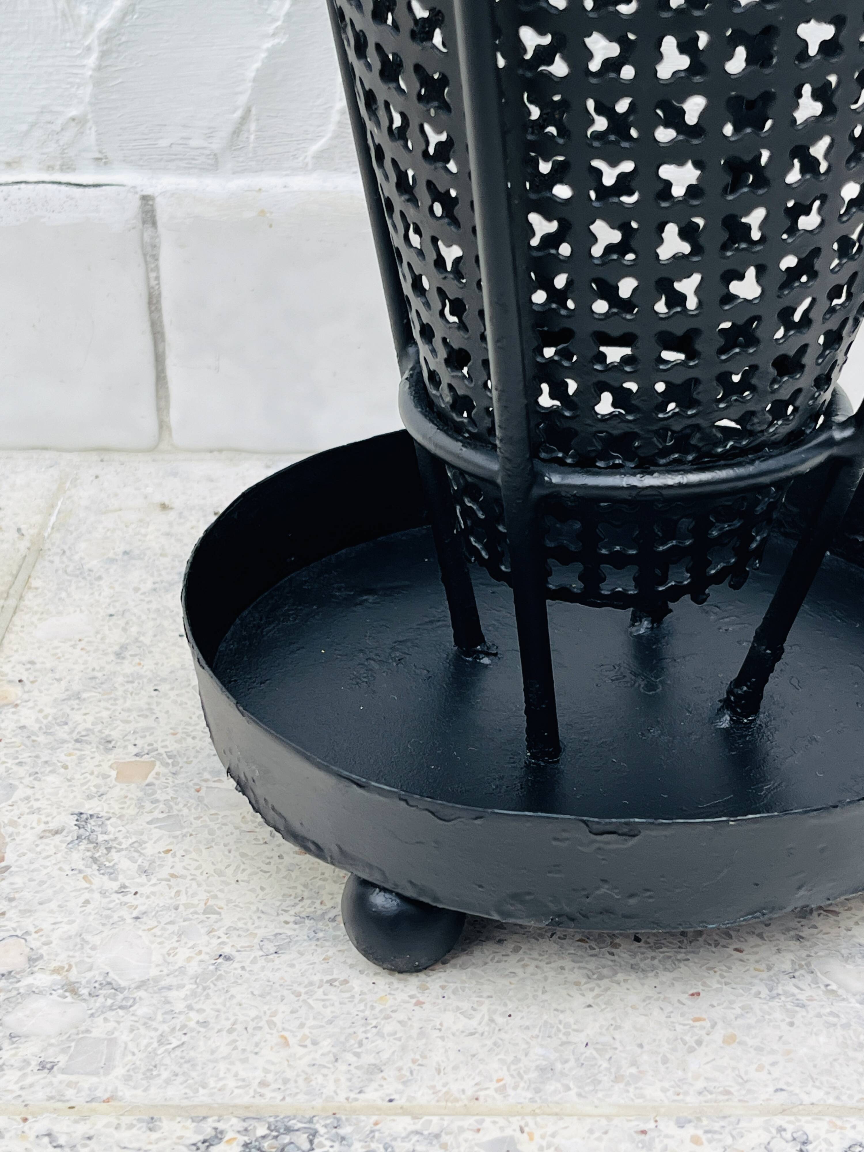 Vintage black perforated metal and brass umbrella stand