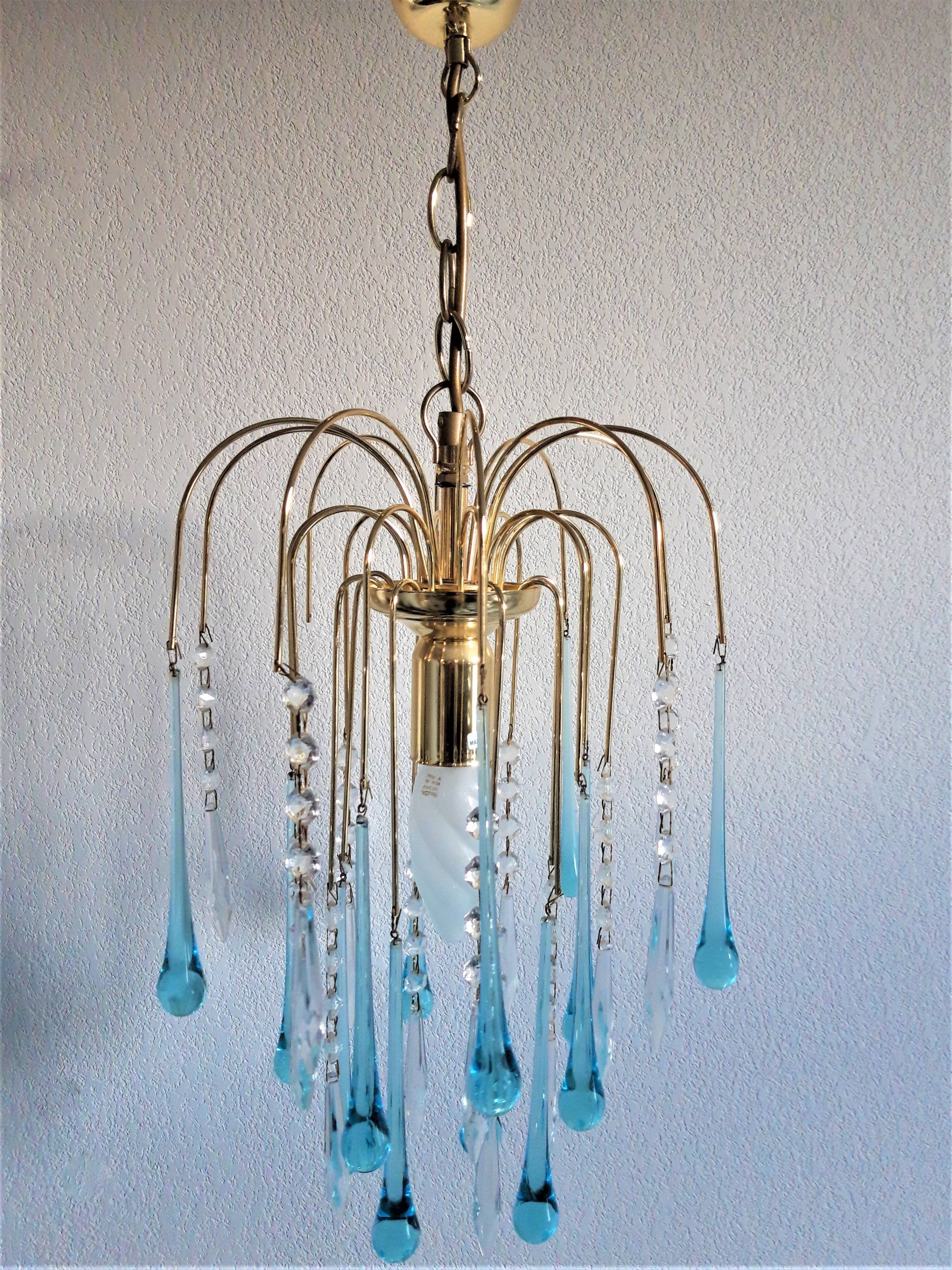 An ancient chandelier with blue tassels
