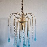 An ancient chandelier with blue tassels